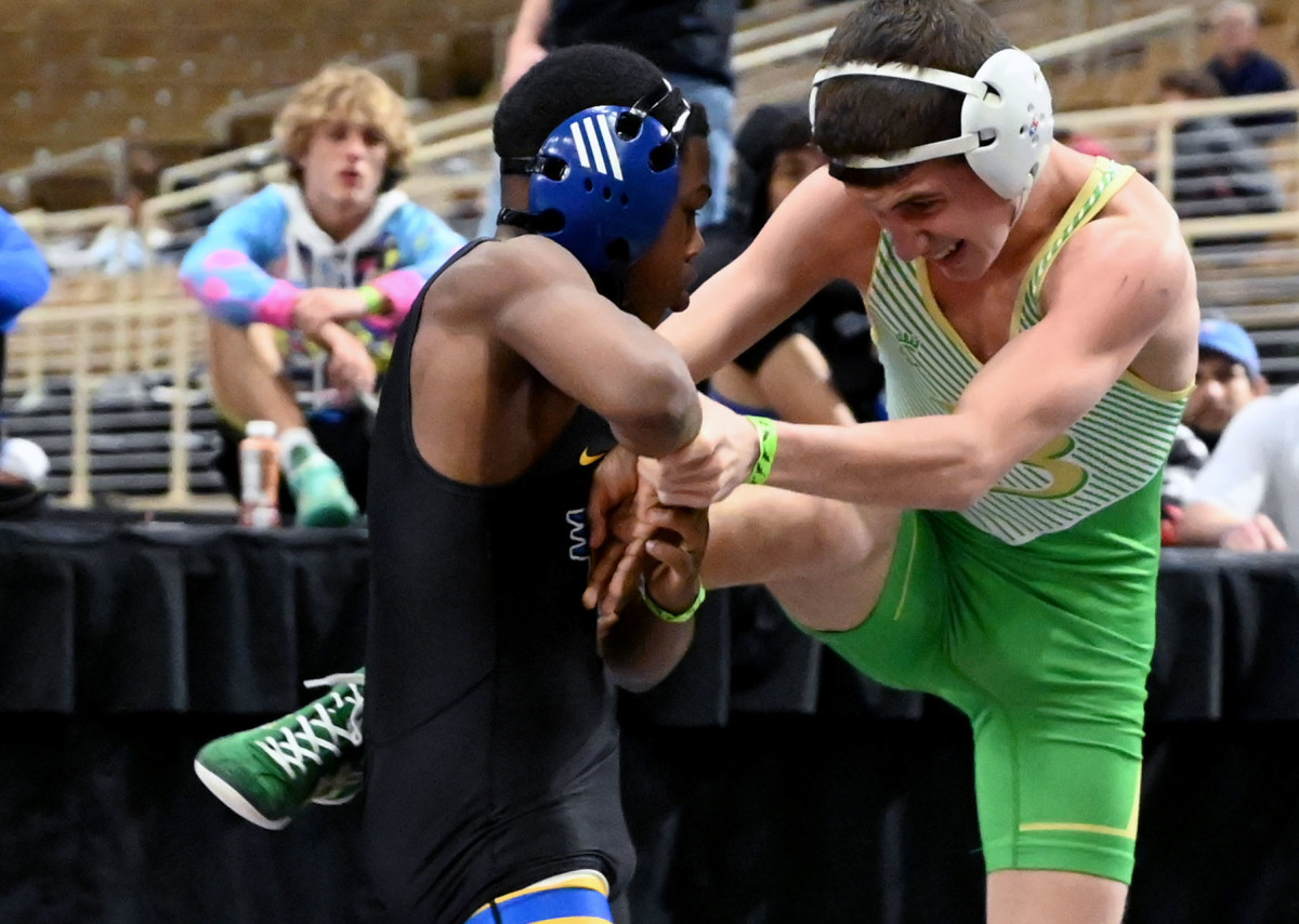 Adaias Ortiz from Osceola advances to the finals with a win over DJ Clarke from Buford during 113-pound semifinals match on Saturday at the Knockout Christmas Classic at Silver Spurs Arena in Kissimmee. 